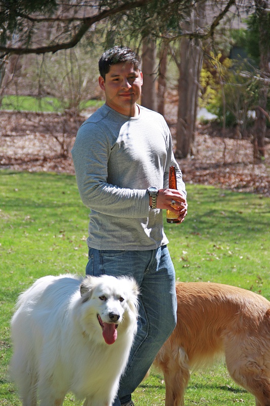 Gabe in Alyssa's and Brad's back yard with Scout and Corby.