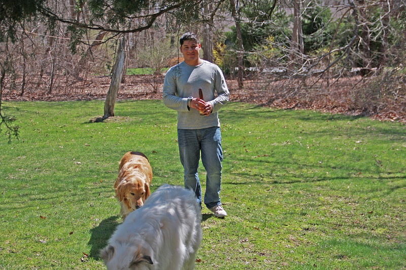Gabe in Alyssa's and Brad's back yard with Scout and Corby.