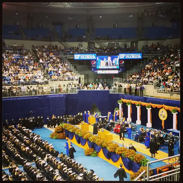 The graduates individually are greeted by UF's president...