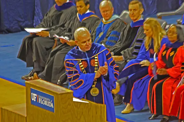 Bernie Machen, UF President applauds the graduates by...