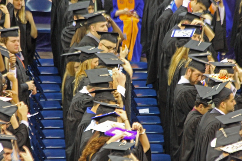 Shane and his classmates flip their tassels to the right to signify their new status as UF grads