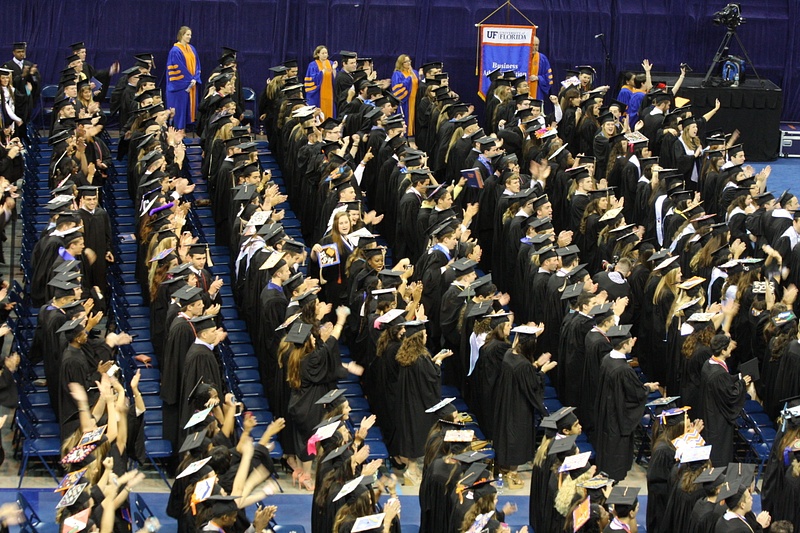 The University of Florida Class of 2104 applaud each other and sing their Alma Mater