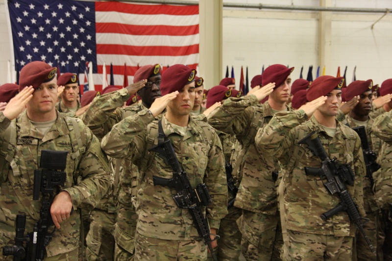 Paratroopers salute the colors as the National Anthem is played