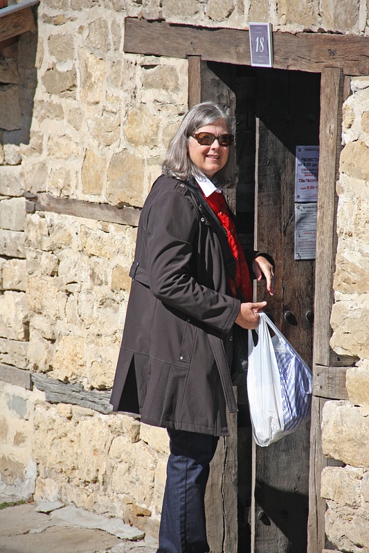 Georgia walks through a timbered entryway in Arbanassi