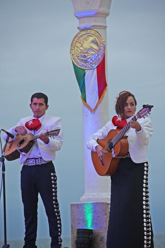 A Mariachi band featuring a female guitarist