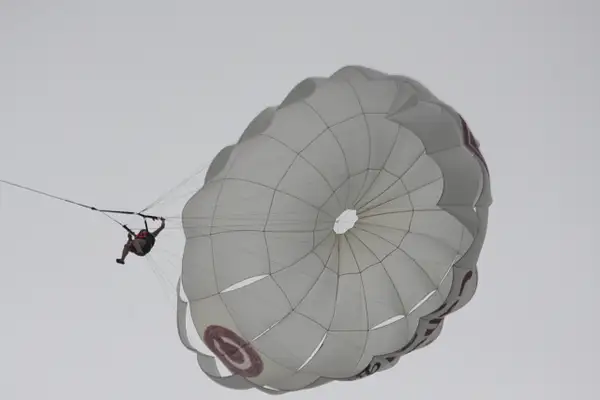 A parasailer floats above the beach by ThomasCarroll235