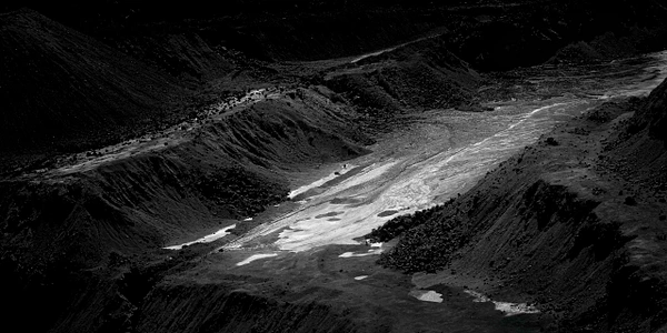 Black-and-white close-up of textured earth and mineral deposits at the Lavender Pit in Bisbee, Arizona.