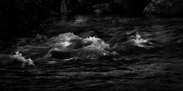 Black-and-white photograph of illuminated ripples on the Verde River in Clarkdale, Arizona.