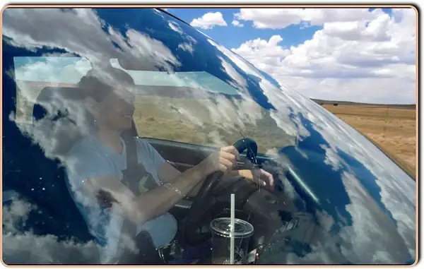 Big Sky Reflection at 60mph over Jeans Windshield by...