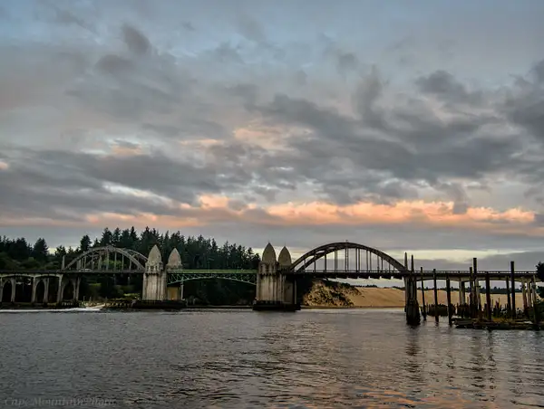 Boat Rushing Under the Bridge at Dawn by jgpittenger