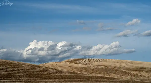 Clouds_Hovering_Over_Newly_Plowed_Fields by jgpittenger