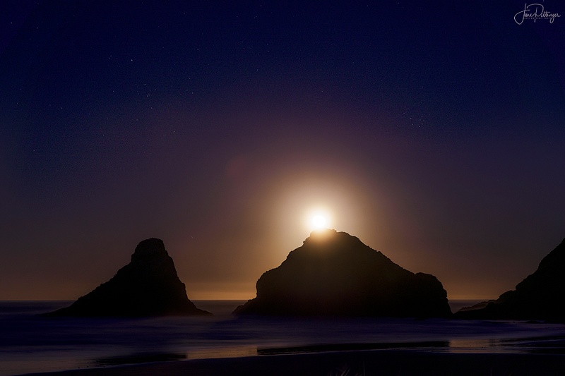 Moon Going Down Behind the Rocks At Heceta Lighthouse Park