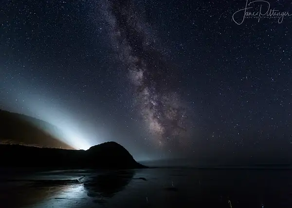 Car Beams Compete with Milky Way At Ocean Beach by...