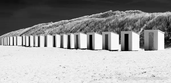 Locker-rooms on the beach on a bright sunny day by...