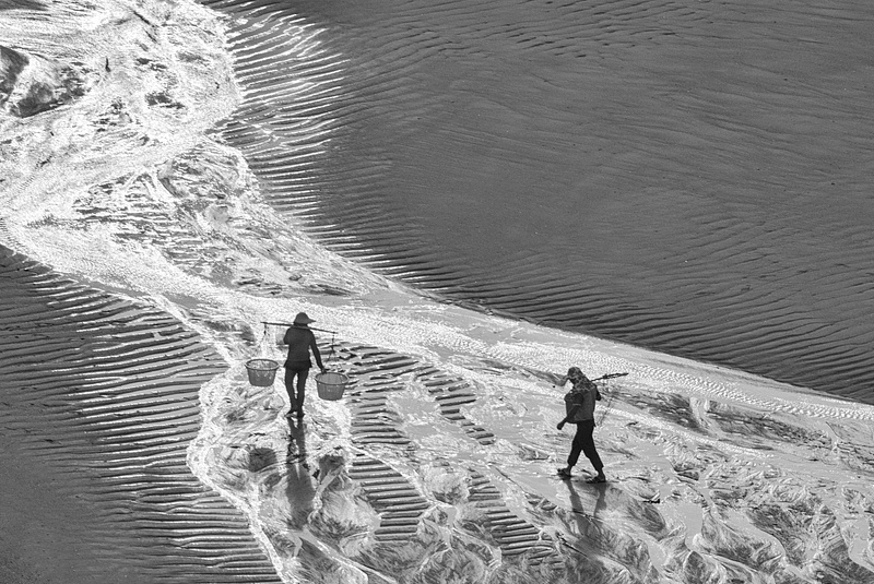 Two Fishermen walking on the low tide mudflat Xia Pu China - Jenny Gu