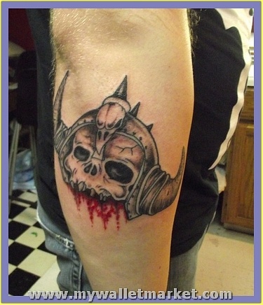 ugly-alien-skull-face-tattoo-on-elbow