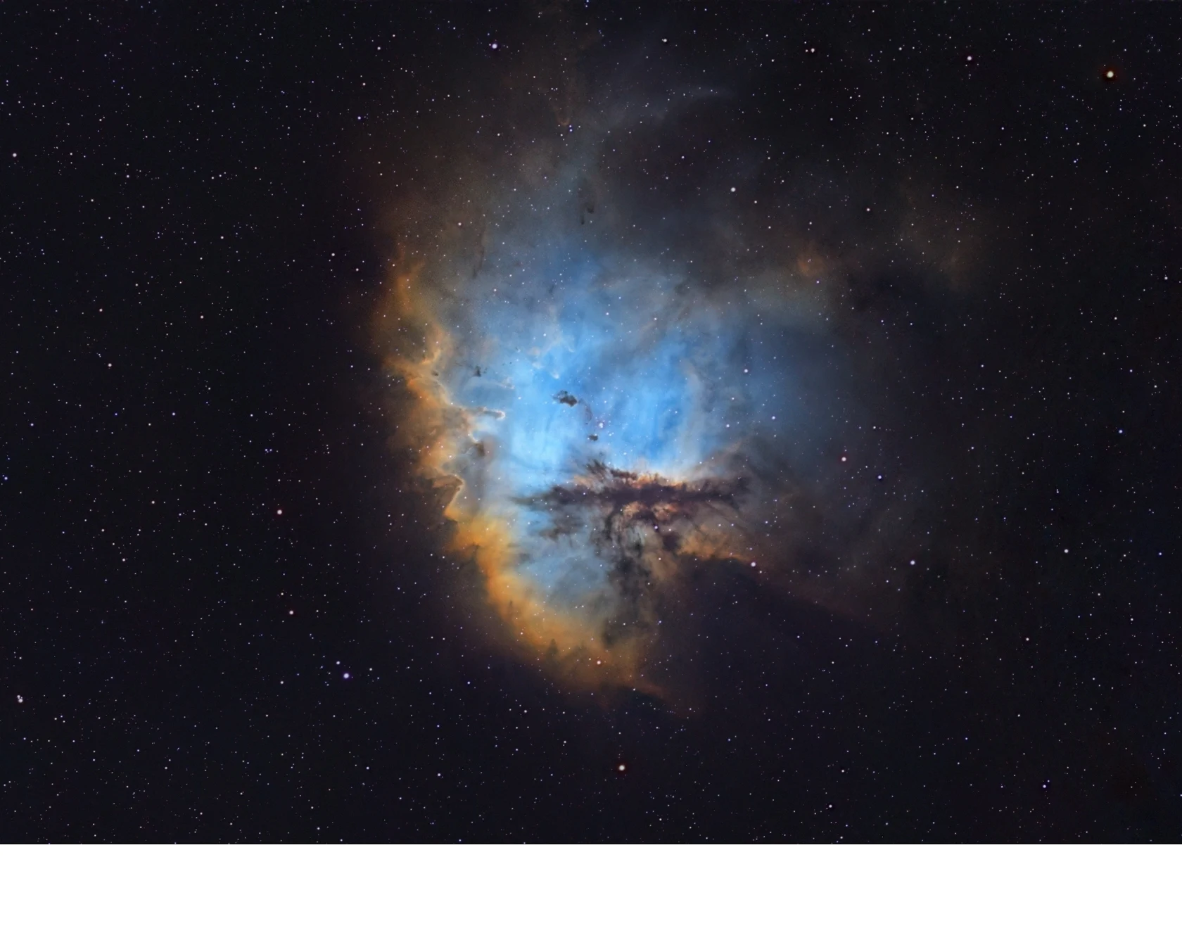 'NGC 281, also known as the _Pacman Nebula,_ consumes gas and dust to spark new stars in the constellation Cassiopeia, showcasin